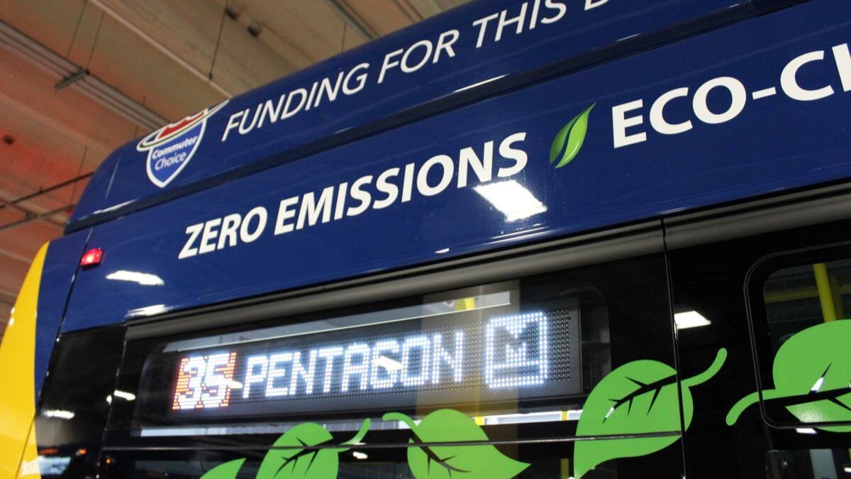 Cropped view of top of transit bus. Bus says Zero Emissions.